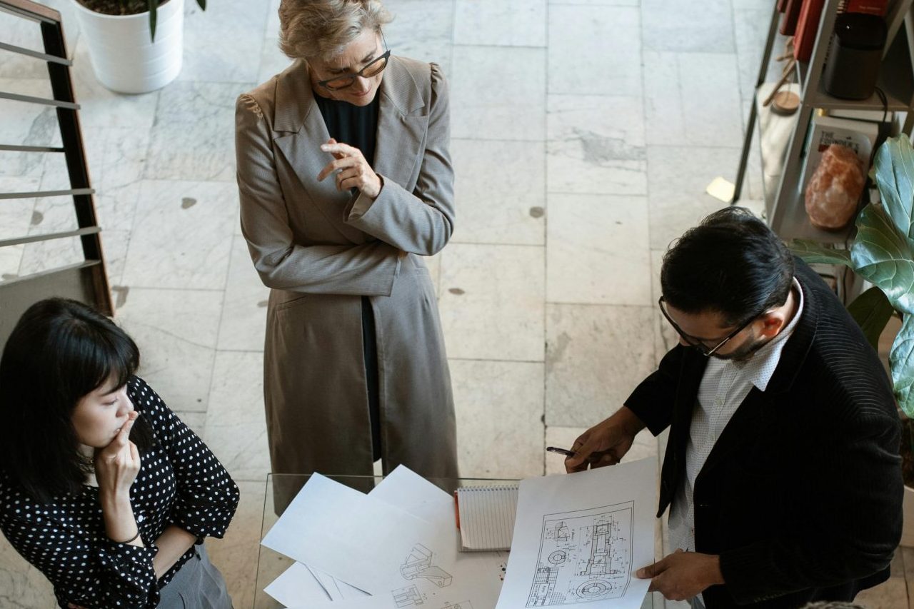 A team of professionals engage in a business meeting in a sleek, modern office setting.